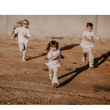 Three children running whilst wearing Sun Dance Flares and Tee