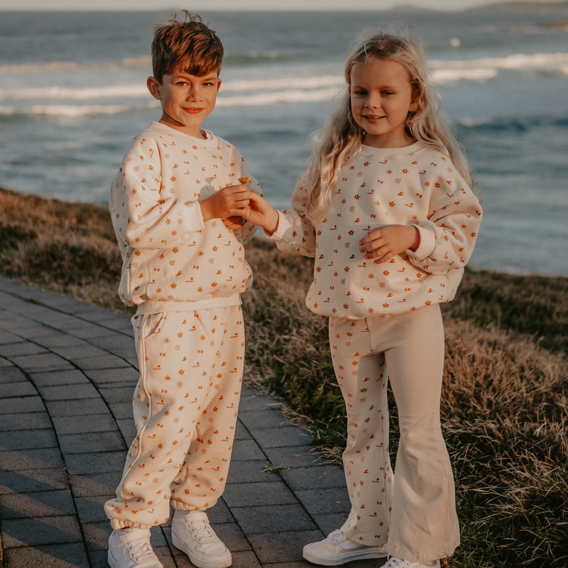 Boy wearing Sun Dance Track Set and Girl wearing Sun Dance Pullover and Flares