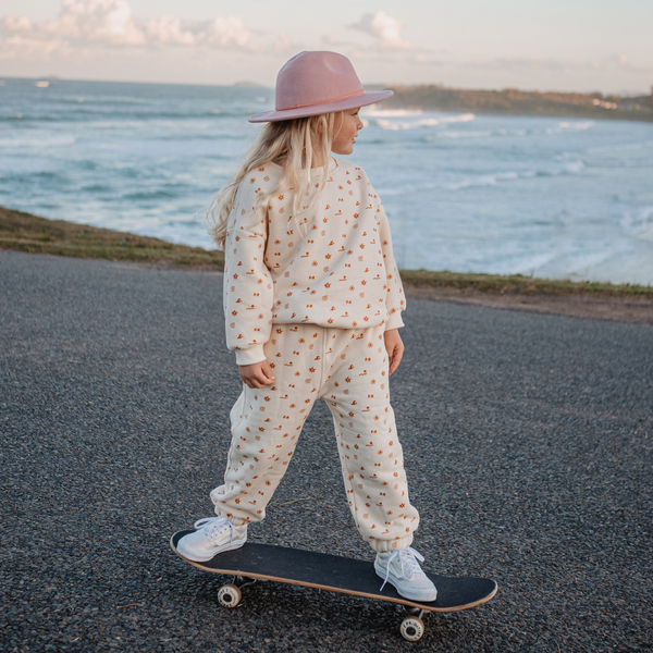 Girl skateboarding while wearing Sun Dance Pullover and Track Pant